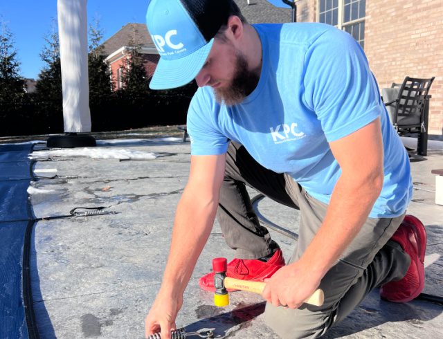 image of a pool cover technician repairing a pool cover near Louisville, KY